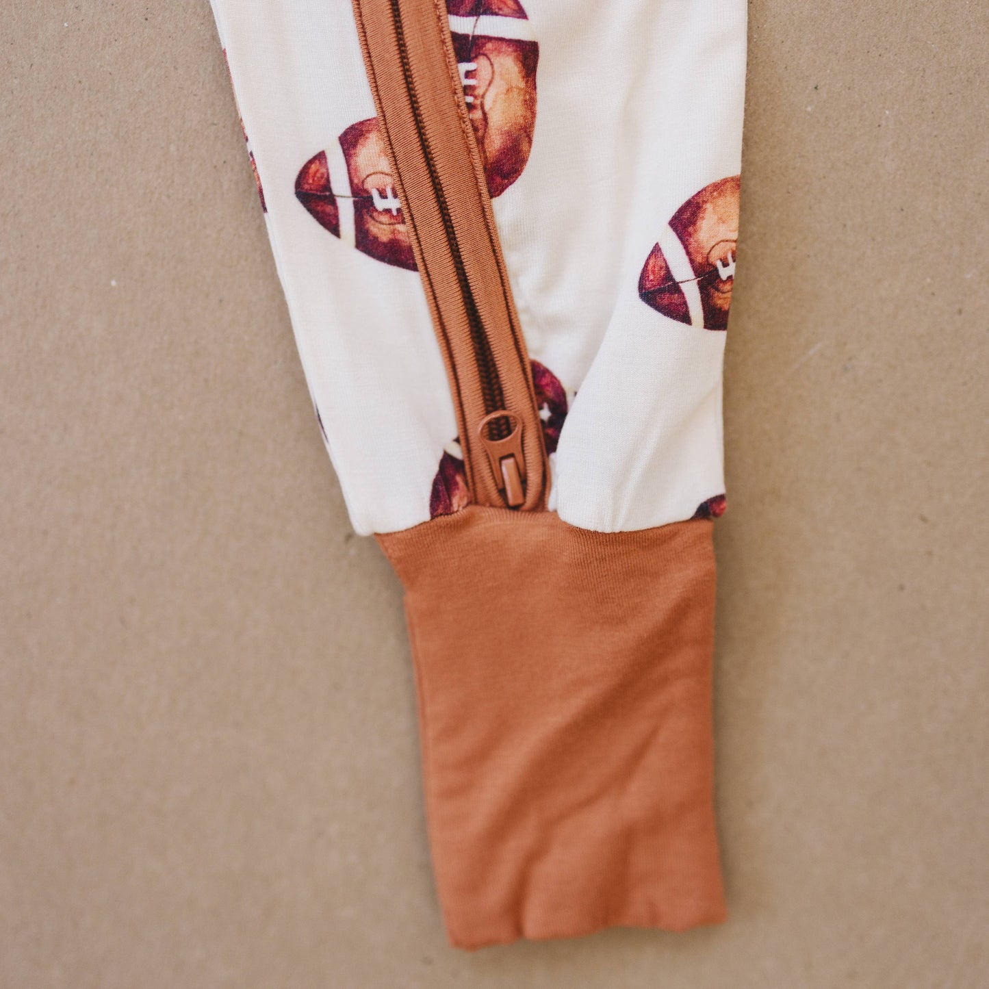 Little Joy Co. - Football Print Bamboo Zippy Romper  IN STOCK